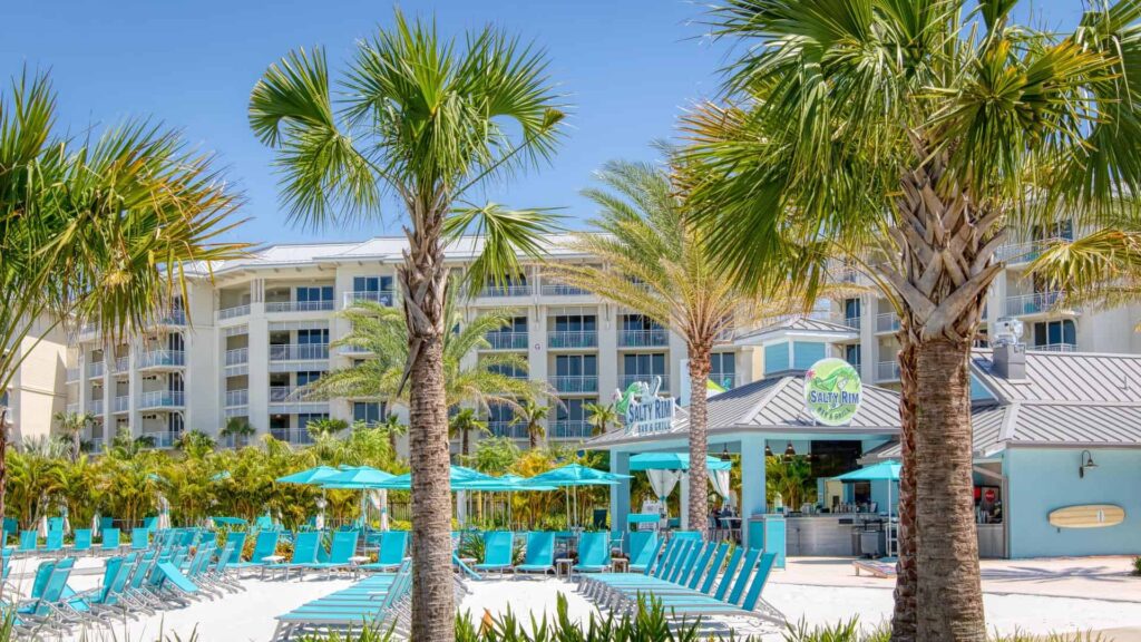 Sun loungers on the sand at Fins Up Beach Club at Margaritaville Resort Orlando.