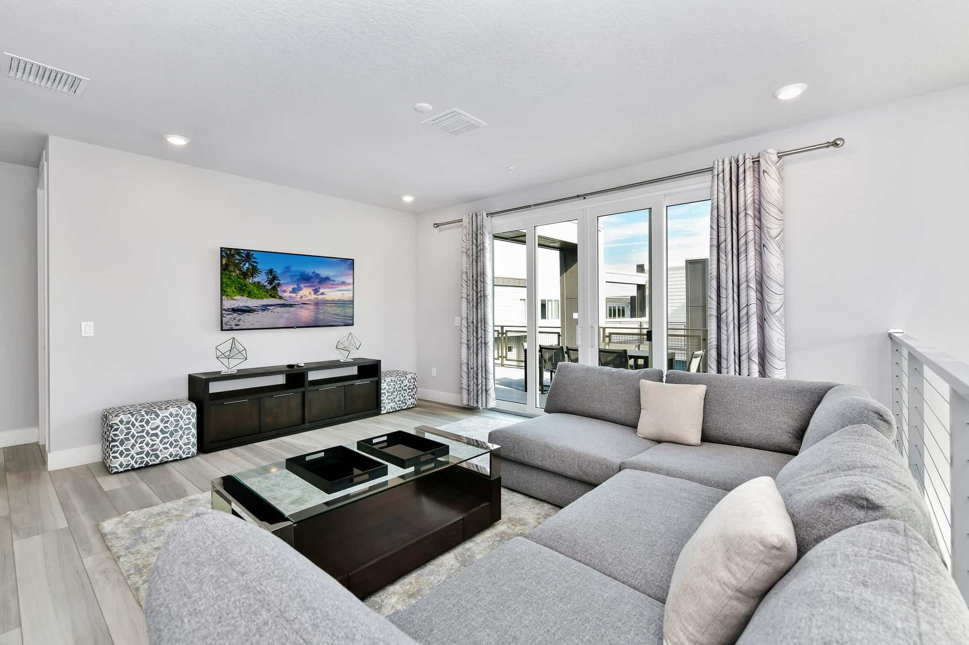 Spectrum Resort Orlando condo loft with sofa, TV, and access to outdoor terrace
