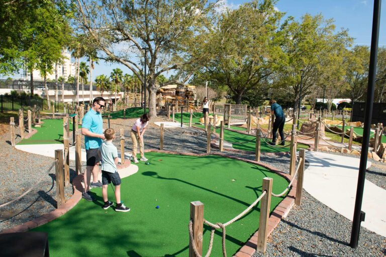 Family playing a round of mini golf at Reunion Resort