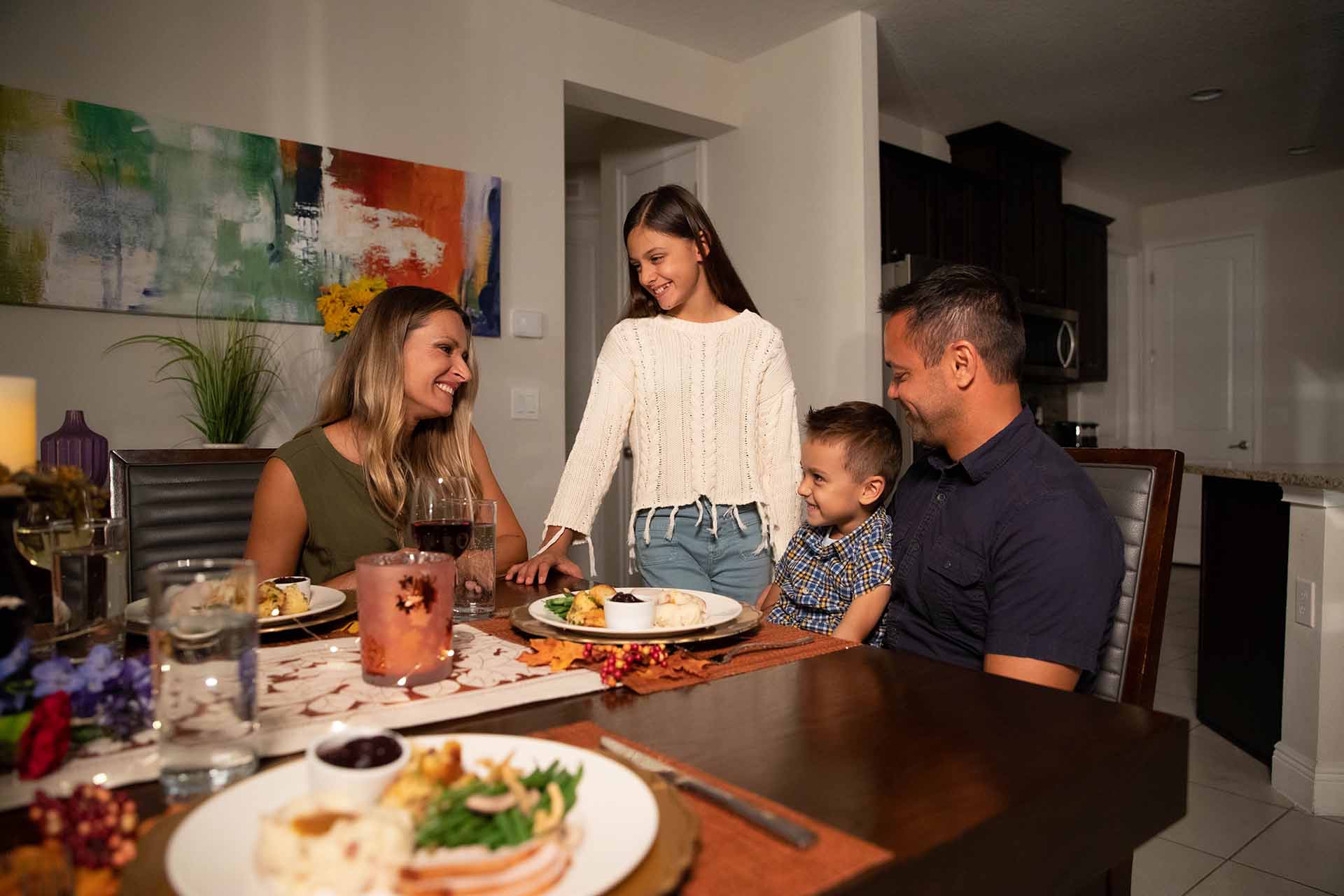 Happy enjoying each other's company around a Thanksgiving feast in their Encore Vacation Home dining room