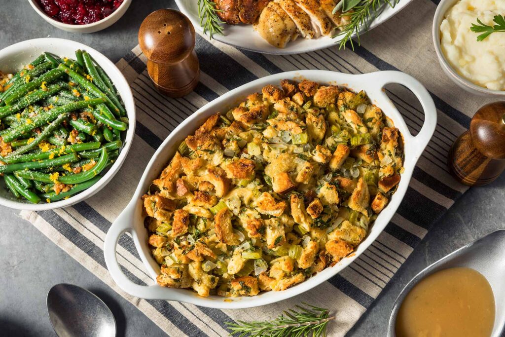 Thanksgiving side dishes including stuffing, green beans, and mashed potatoes