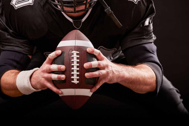 American football player holding a football