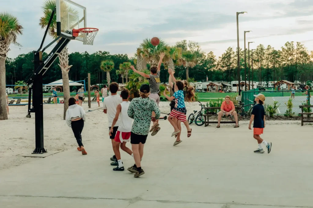 Kids playing basketball on a court at Island Oaks