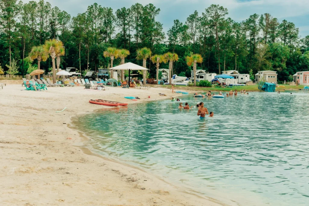 Families on the beach and in the lake at Island Oaks
