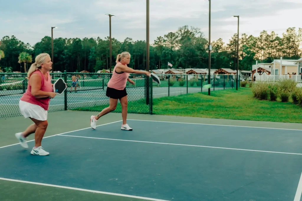 Women playing pickleball on a court at Island Oaks